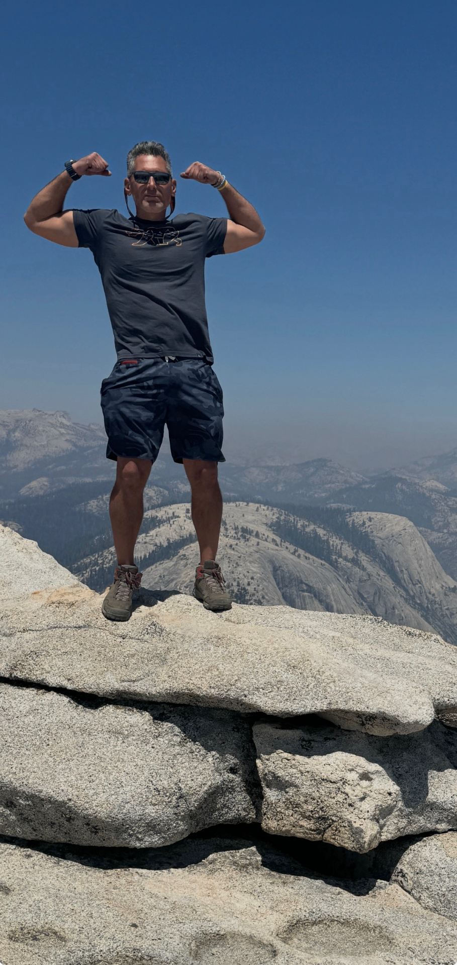 Summit pose atop a granite peak